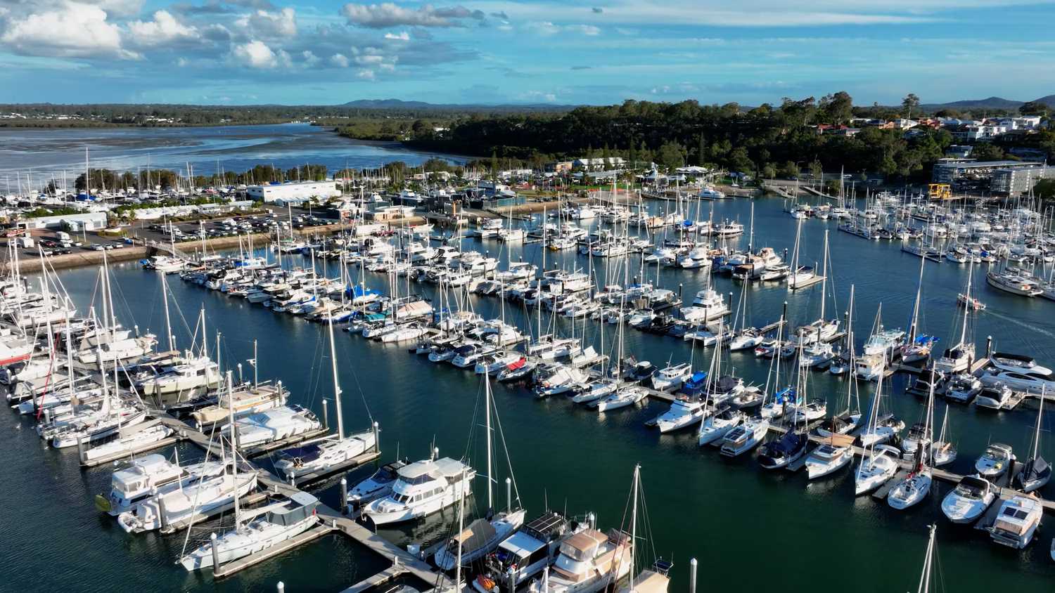 Aerial view of a coastal marina filled with boats